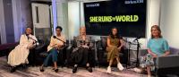 Five women sit on chairs with microphones. Behind them text reads SiriusXM and She Runs the World
